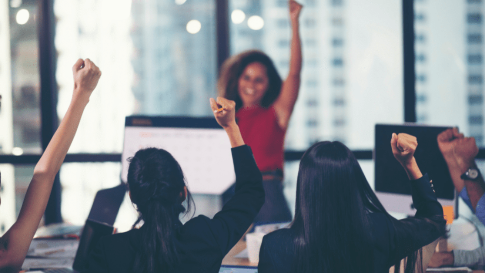 Colleagues cheer during a presentation