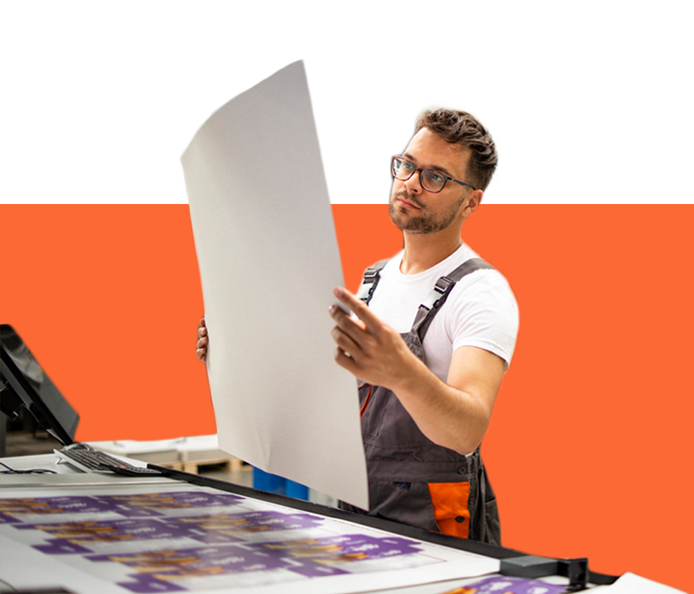 A draftsman inspects a large-scale printout.